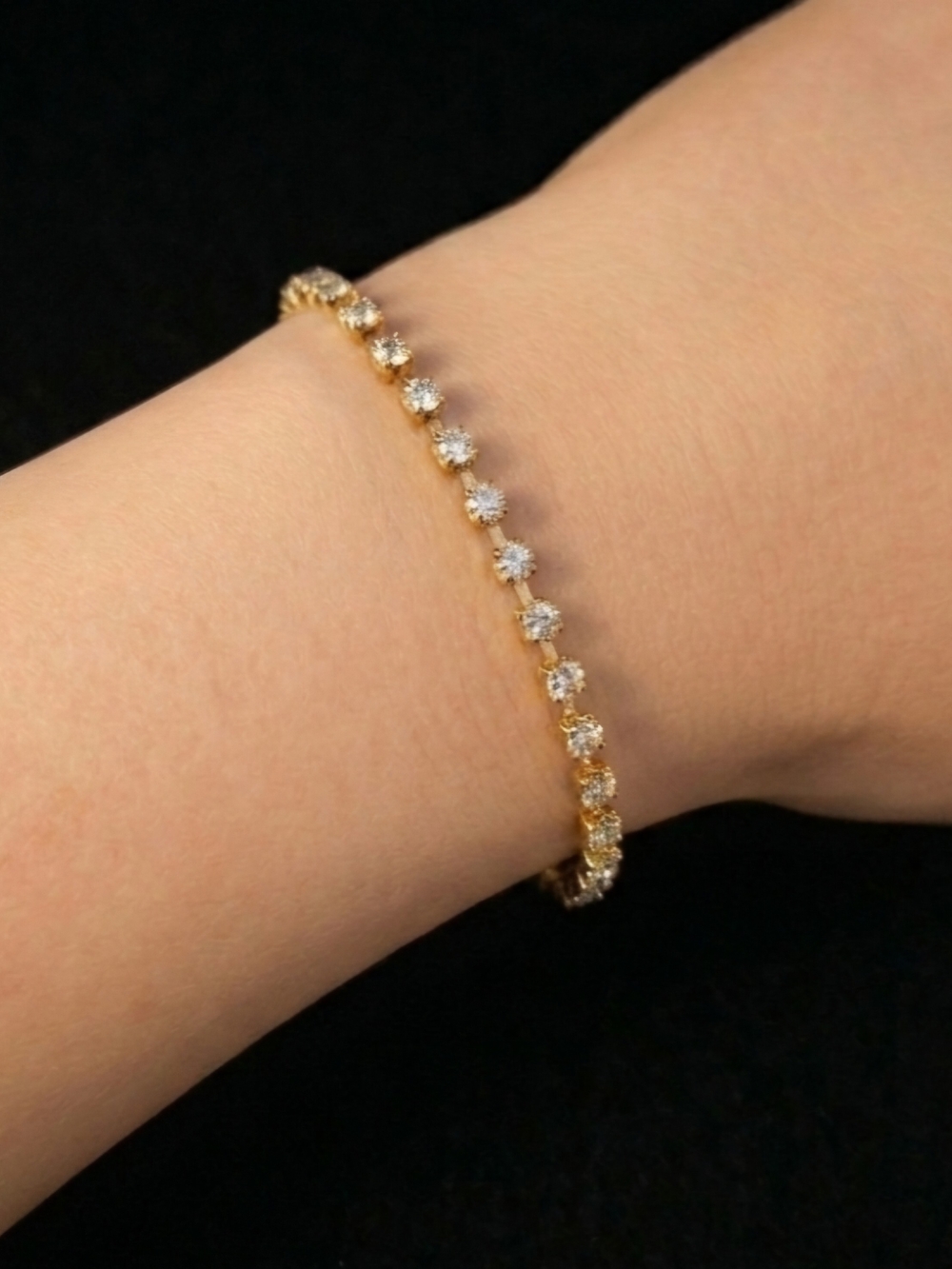 Gold-Tone Tennis Bracelet with Cubic Zirconia Square Stones.